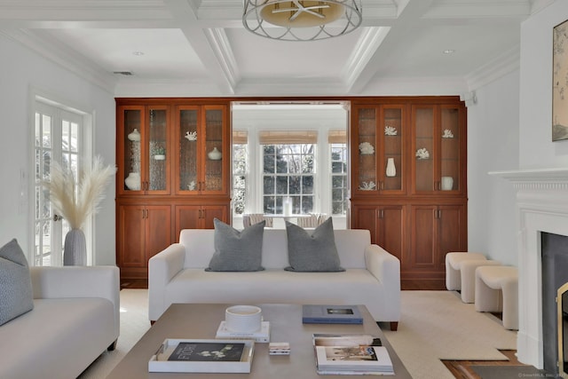 living room featuring visible vents, a fireplace with flush hearth, ornamental molding, coffered ceiling, and beamed ceiling