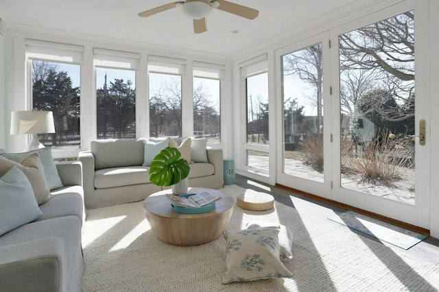 sunroom / solarium featuring a ceiling fan