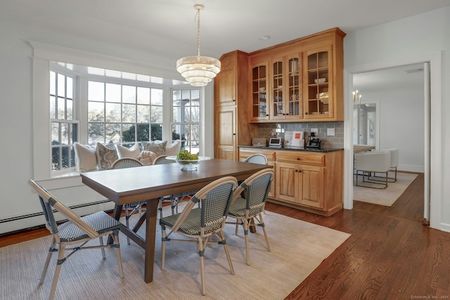 dining area with wood finished floors and baseboards