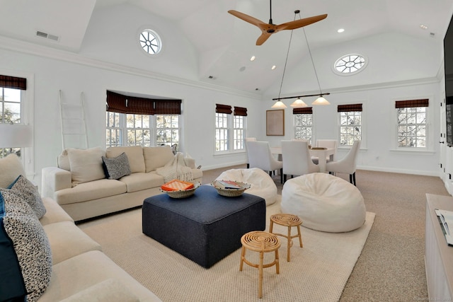 living area with high vaulted ceiling, visible vents, and baseboards