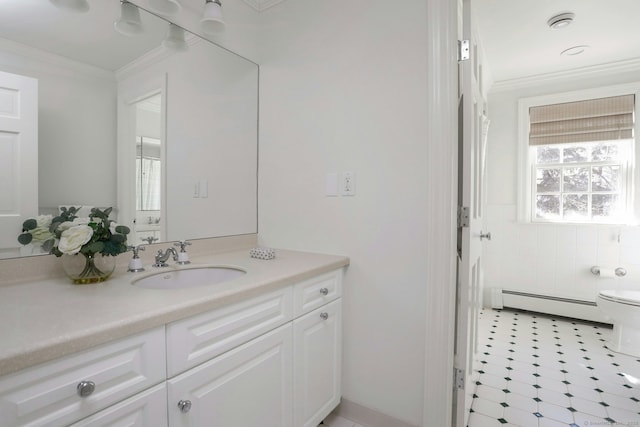 bathroom featuring ornamental molding, baseboard heating, vanity, and toilet