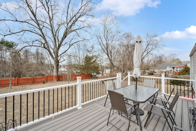 deck with outdoor dining space and fence