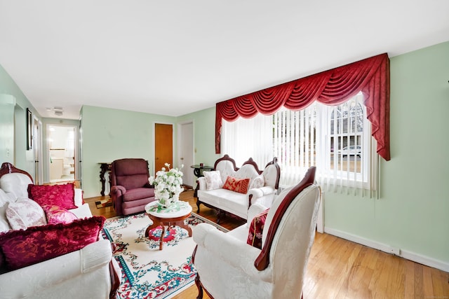 living room with baseboards and wood finished floors