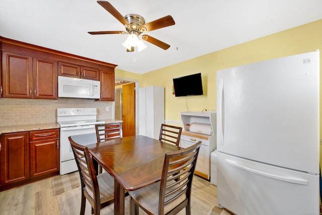 dining area featuring a ceiling fan and light wood-style floors