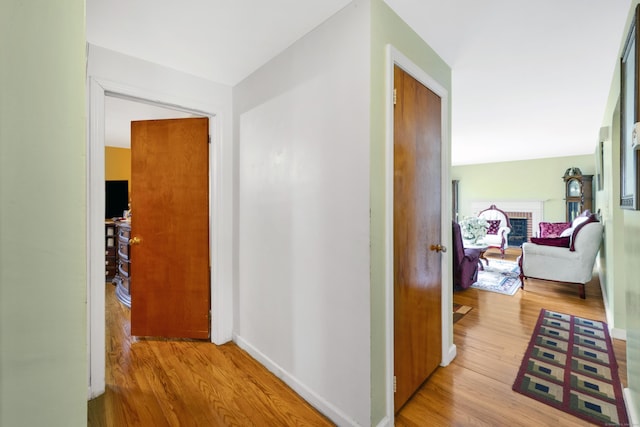 hall featuring baseboards and wood finished floors