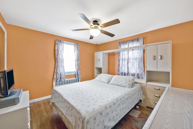 bedroom with baseboards, wood finished floors, and a ceiling fan