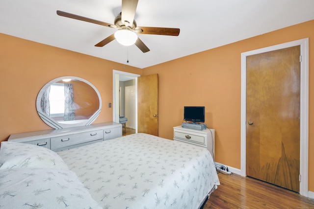 bedroom featuring baseboards, ceiling fan, and wood finished floors