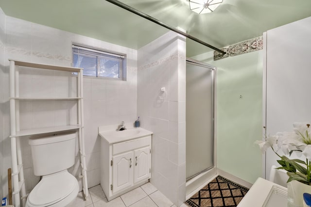 full bathroom featuring toilet, tile walls, a stall shower, and tile patterned flooring