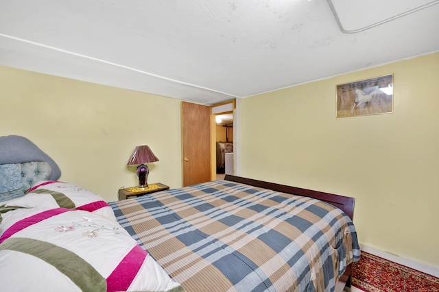 bedroom featuring baseboards and carpet