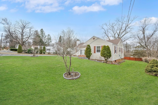 view of yard with a garage and fence