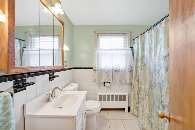 bathroom featuring toilet, radiator heating unit, tile patterned flooring, and a wealth of natural light