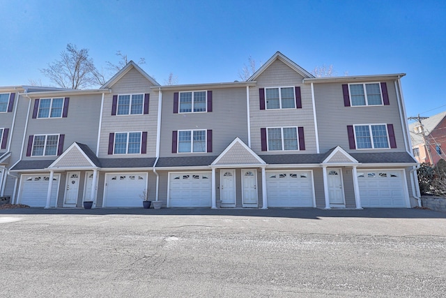 multi unit property featuring an attached garage