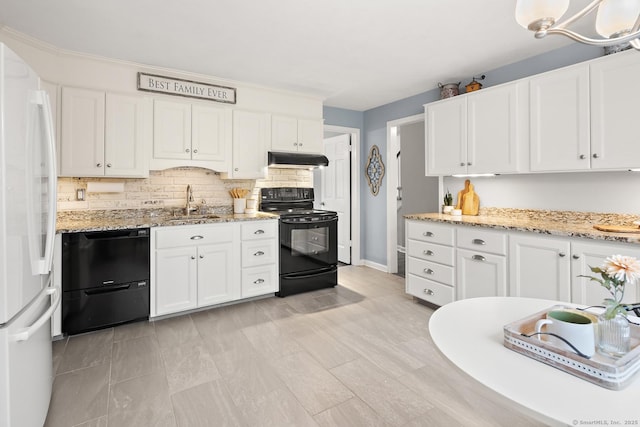 kitchen with under cabinet range hood, a sink, white cabinetry, backsplash, and black appliances