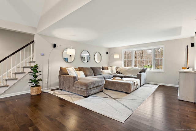 living area featuring stairway, hardwood / wood-style flooring, and baseboards