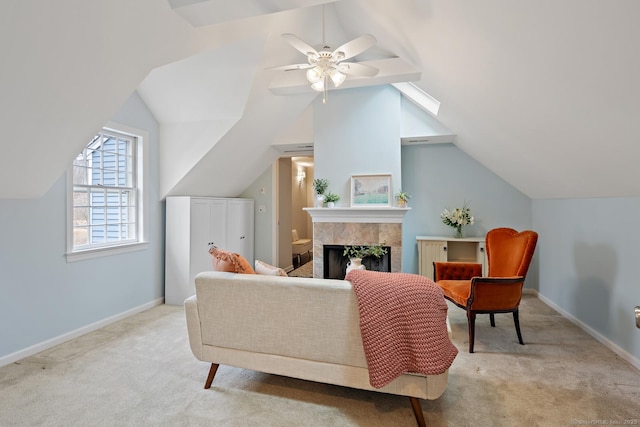 living area with a tiled fireplace, carpet, lofted ceiling, and baseboards