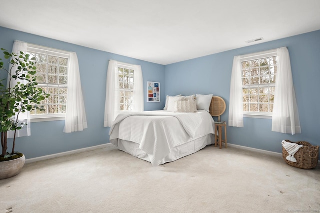 bedroom featuring carpet flooring, visible vents, and baseboards