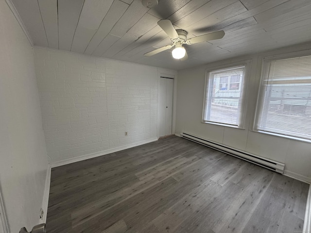 unfurnished room featuring a baseboard heating unit, ceiling fan, brick wall, wood finished floors, and wooden ceiling