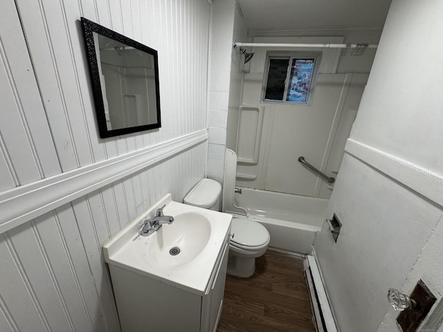 bathroom with bathing tub / shower combination, toilet, wood finished floors, baseboard heating, and vanity