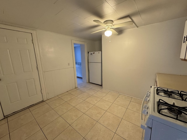 kitchen featuring ceiling fan, light countertops, white appliances, and light tile patterned flooring