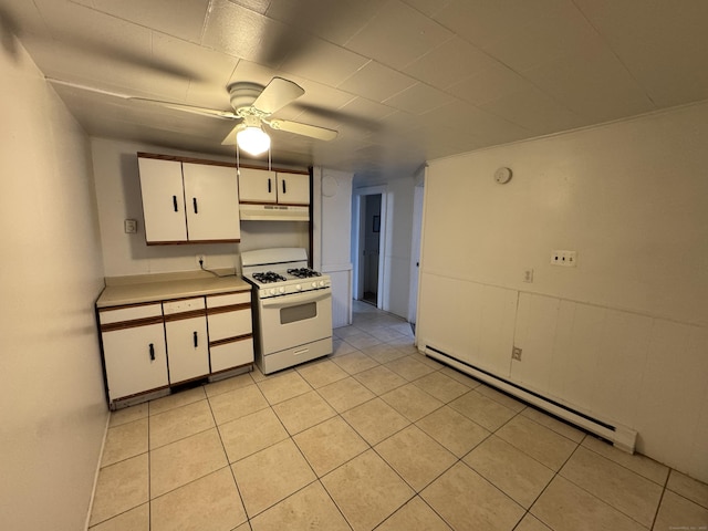 kitchen with a baseboard radiator, under cabinet range hood, white cabinets, white range with gas cooktop, and light countertops