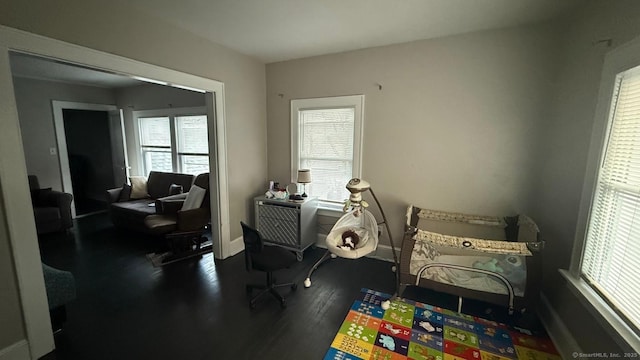 game room featuring wood finished floors, a wealth of natural light, and baseboards