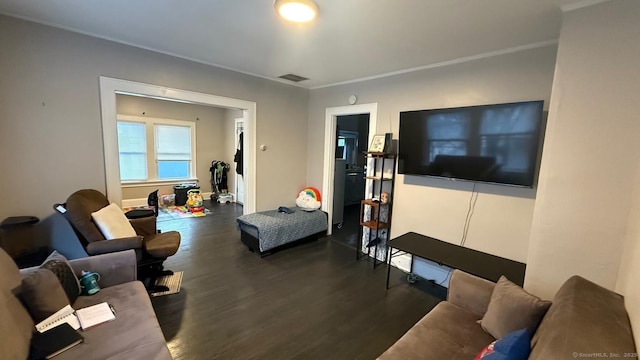 living area featuring visible vents and dark wood-type flooring