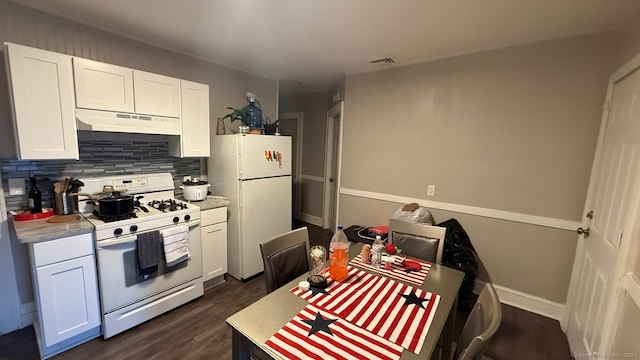 kitchen featuring under cabinet range hood, white appliances, visible vents, white cabinets, and light countertops