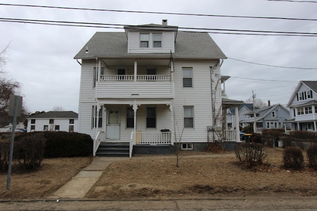 view of front facade with a balcony and a porch