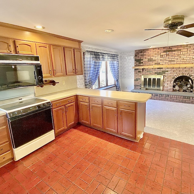 kitchen with range with electric cooktop, black microwave, light countertops, and a fireplace