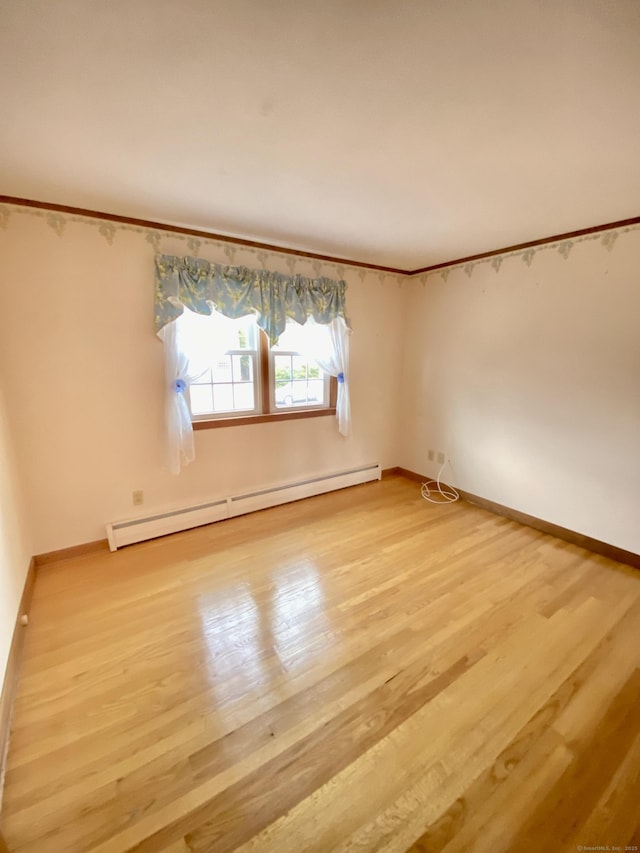 unfurnished room with light wood-style floors, baseboards, and baseboard heating