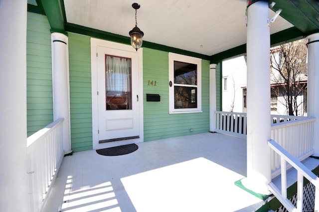 view of exterior entry with covered porch