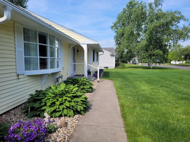 view of side of home featuring a lawn