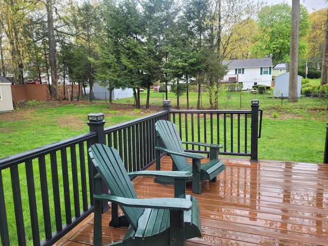 wooden deck featuring a fenced backyard and a yard