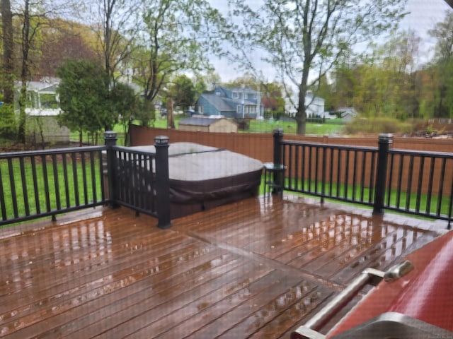 wooden deck with a lawn and fence