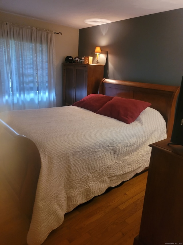 bedroom featuring wood finished floors