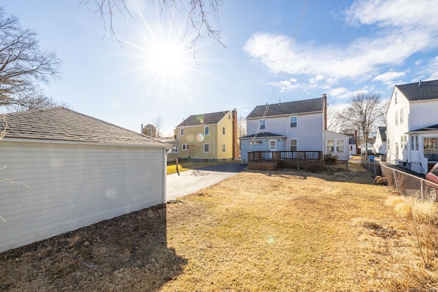 view of yard featuring a patio, a deck, and fence