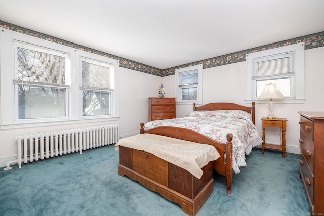 carpeted bedroom featuring baseboards and radiator heating unit