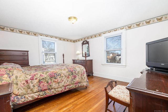 bedroom featuring baseboards and wood finished floors