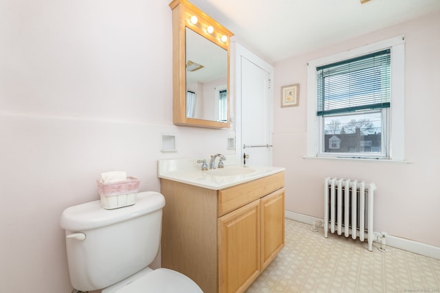 bathroom featuring radiator, baseboards, toilet, tile patterned floors, and vanity