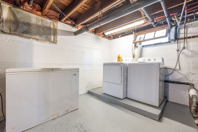 below grade area with washer and dryer and refrigerator