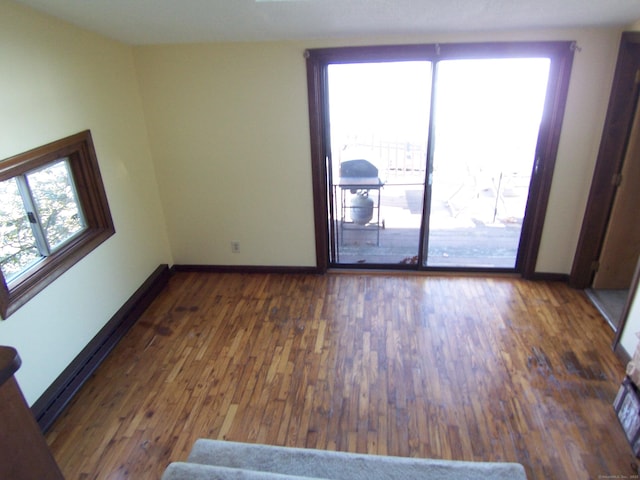 empty room featuring baseboards and wood finished floors