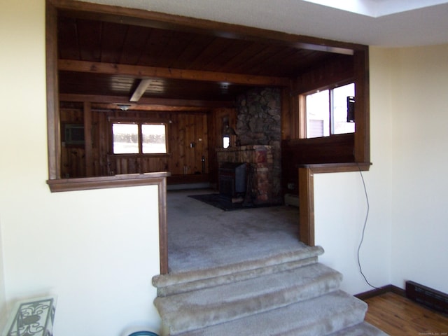 staircase with wooden ceiling, a healthy amount of sunlight, and beamed ceiling