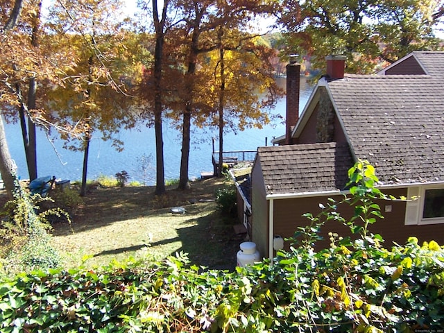 view of side of property with a shingled roof