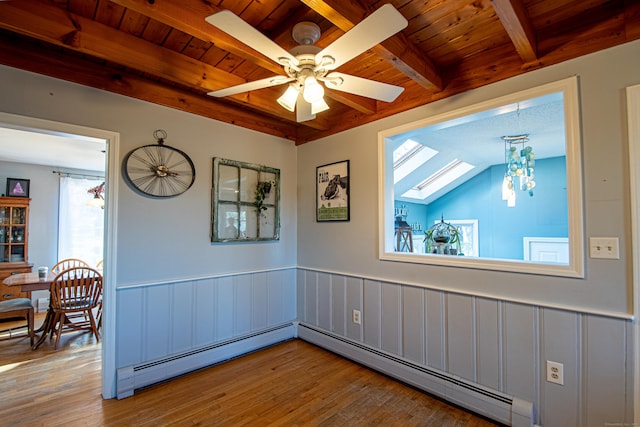 spare room featuring wooden ceiling, baseboard heating, beamed ceiling, and wood finished floors