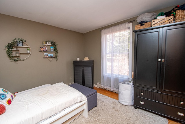 bedroom with wood finished floors and baseboards