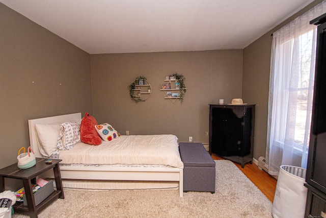 bedroom featuring light wood-type flooring and multiple windows