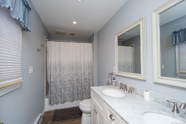 bathroom with a baseboard radiator, a sink, toilet, and double vanity