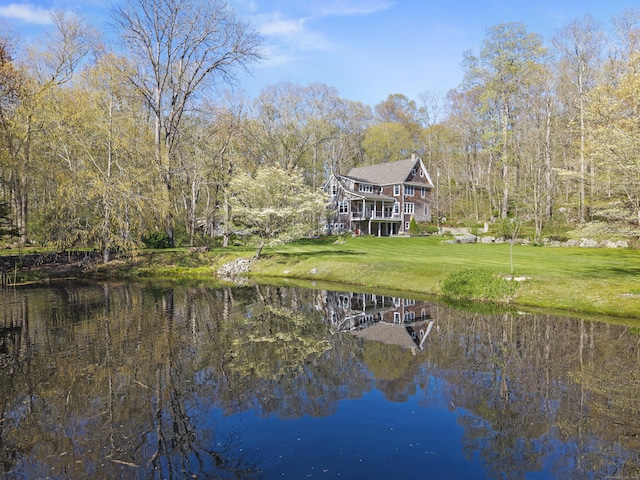 exterior space with a lawn and a water view