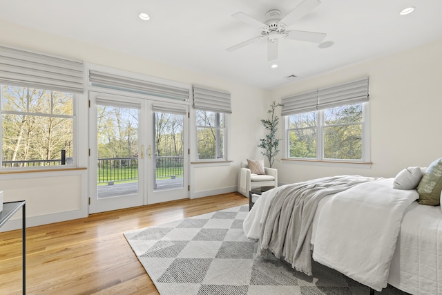 bedroom with french doors, baseboards, light wood-style floors, access to outside, and recessed lighting