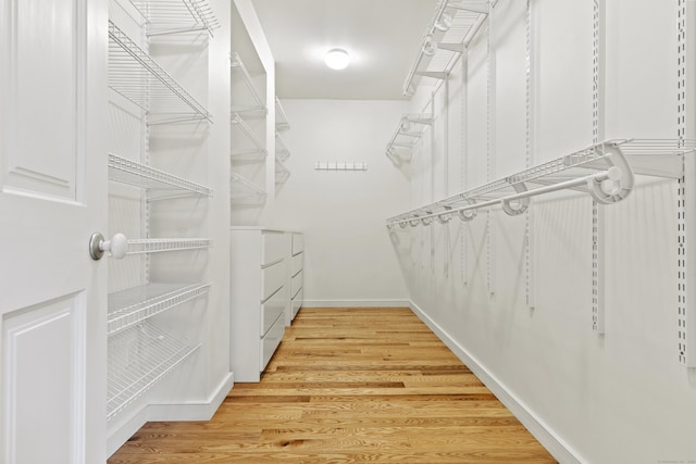 walk in closet featuring washer and dryer and light wood-type flooring